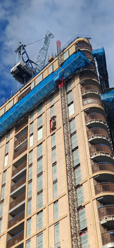 Construction crane beside a building being worked on in London