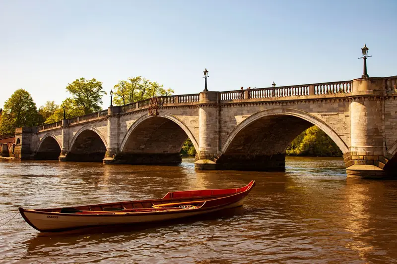 Richmond Bridge over the River Thames with a moored boat