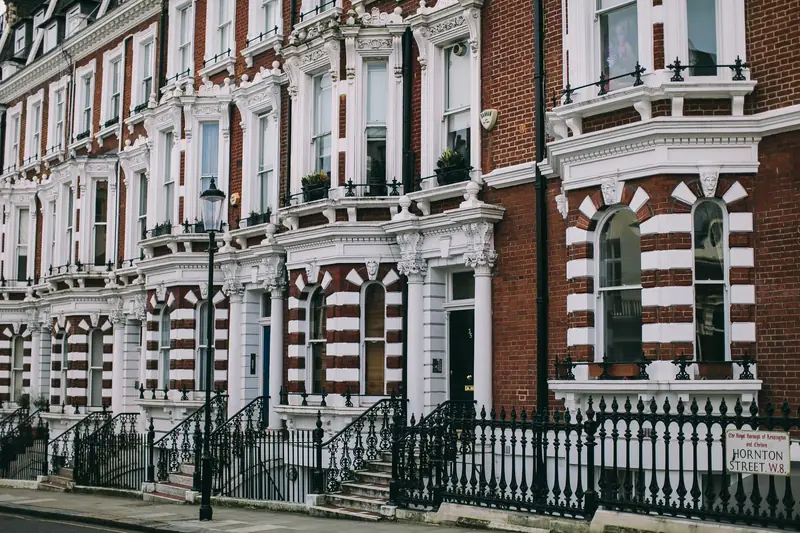 Terrace of Victorian townhouses with shared party walls on a London street
