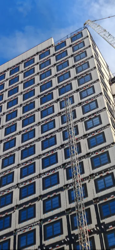 Scaffolded London building with a crane above the roof